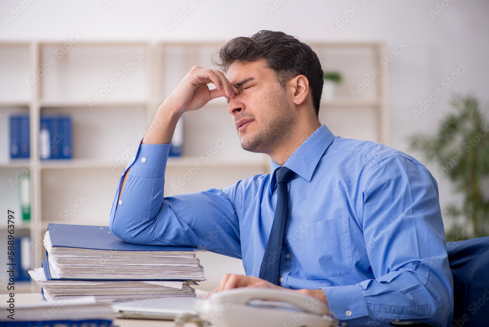 Young male employee working in the office Young male employee working in the office