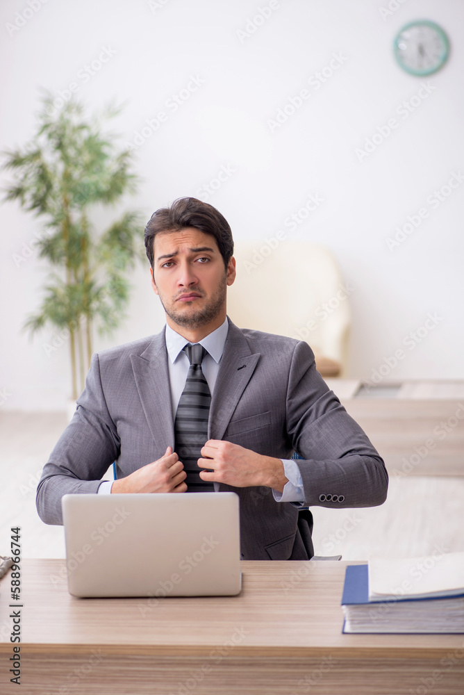 Young male employee working in the office