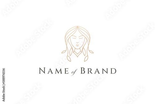 woman face logo with hair decorated with leaves in gold line art design style