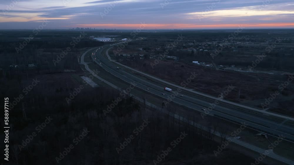 Aerial view of the highway turning towards the city on the horizon Aerial view of the highway turning towards the city on the horizon