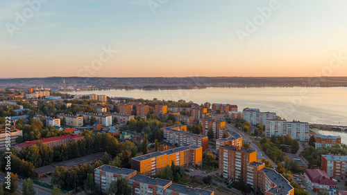 Russia, Votkinsk. Embankment with a dam and factories. Votkinsk is a city in the Udmurt Republic. Sunset time, Aerial View