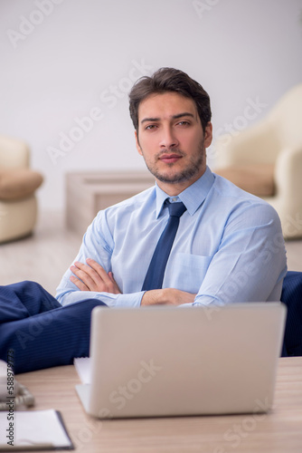 Young male employee working in the office