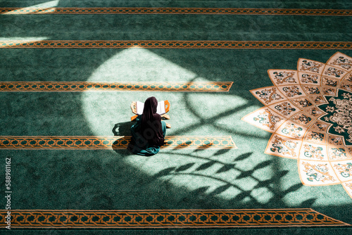 A Muslim woman praying inside the mosque. photo