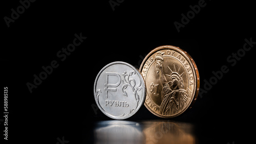 Coin with Russian ruble symbol and 1 US dollar coin with Statue of Liberty