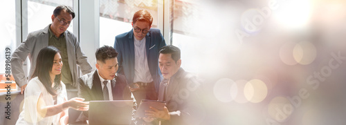 Group of Asian business people wearing suit working discuss and sharing ideas investment strategy concept with laptop computer on sofa in office company