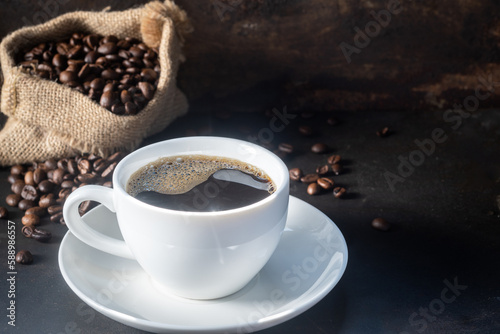 A cup of fresh coffee on rusty metal wall with copy space.