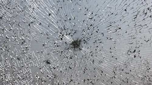 Broken windshield of a car close-up as a background. Texture broken glass with cracks.