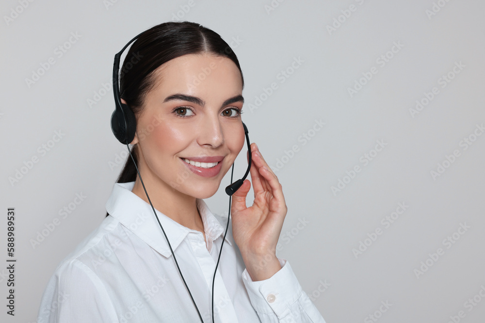 Hotline operator with modern headset on light grey background, space for text. Customer support Hotline operator with modern headset on light grey background, space for text. Customer support