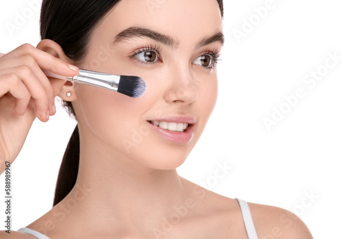 Teenage girl with makeup brush on white background