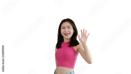 Waving hand in hi, Asian woman smiling friendly greeting, Hello,nice to meet you,say hi, Say hi and greet you, Welcome new people Join a multicultural team, Goodbye, Isolated on yellow background. © Puwasit Inyavileart