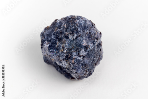 Crystal of cordierite iolite gem stone, raw mineral, white background photo