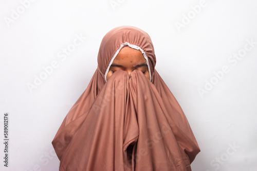 Islamic moslem woman praying wearing traditional dress