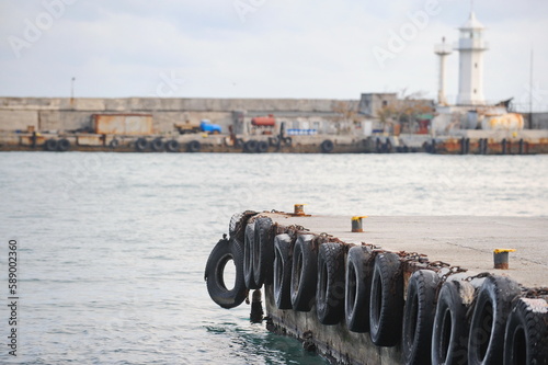 Yalta, Crimea - 10.17.2015 : Pier decorated with old tires on the Black Sea coast.