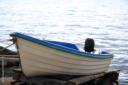 Moored boat on beach near sea outdoors