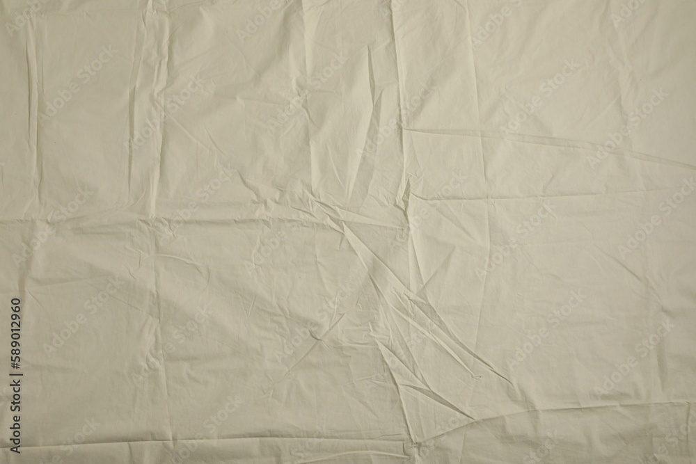 Crumpled beige fabric as background, top view Crumpled beige fabric as background, top view