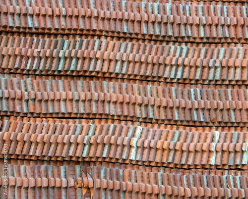 Brown roof tiles lined up in a long line.