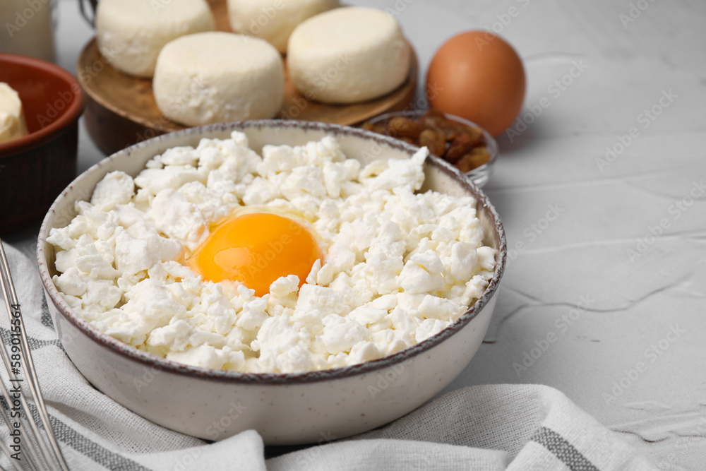 Different ingredients on white textured table, space for text. Cooking cottage cheese pancakes Different ingredients on white textured table, space for text. Cooking cottage cheese pancakes
