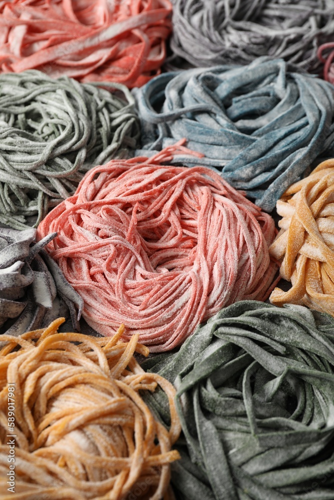 Rolled pasta painted with food colorings as background, closeup Rolled pasta painted with food colorings as background, closeup