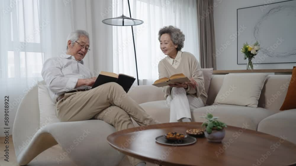 Cheerful senior couple reading book at home,4K Cheerful senior couple reading book at home,4K