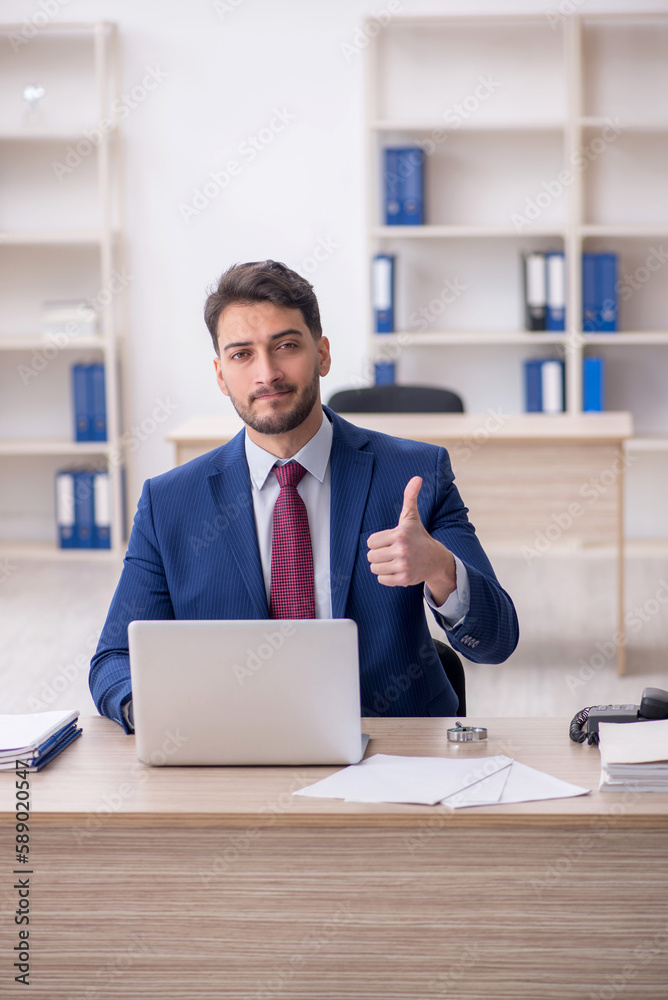 Young male employee working in the office Young male employee working in the office