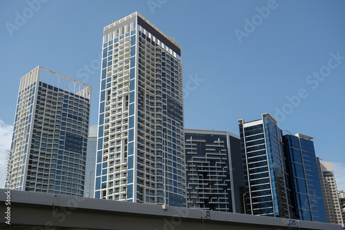 Futuristic and modern commercial and residential highrise tower skyscraper architecture with glass facades and clean lines in downtown Dubai, United Arab Emirates for millionaires and high society