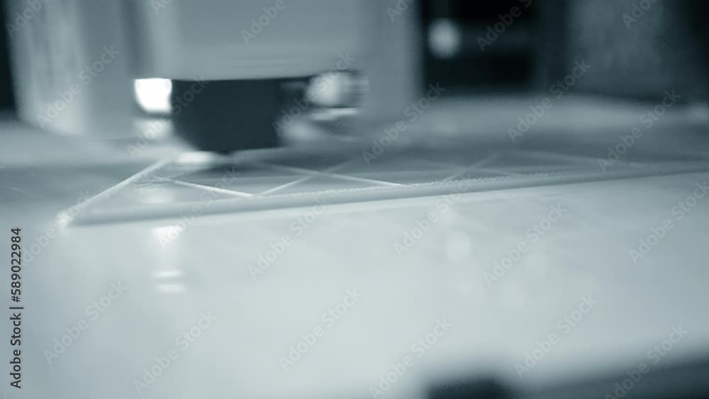 3D printer. 3d printer printing close-up. Molten plastic flowing out of extruder and forming prototype model. New modern additive technologies for printing 3D printer. Electronic device for modeling. 3D printer. 3d printer printing close-up. Molten plastic flowing out of extruder and forming prototype model. New modern additive technologies for printing 3D printer. Electronic device for modeling.