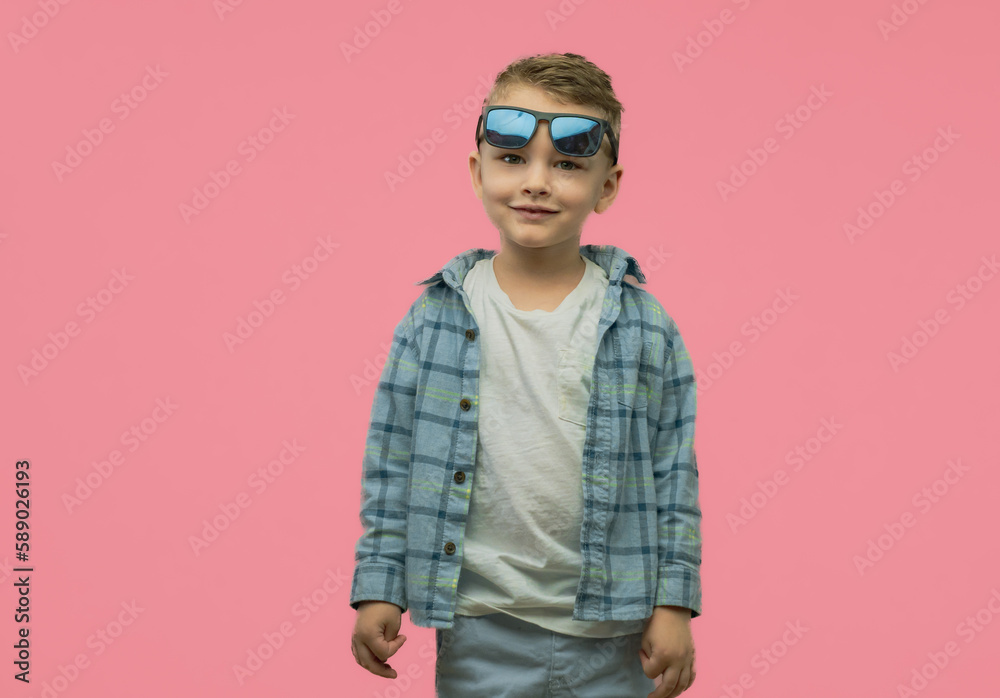Little boy posing in studio on pink background. Looking up. Copy space Little boy posing in studio on pink background. Looking up. Copy space