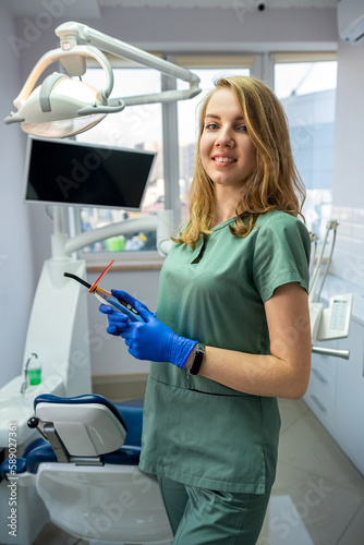 young female dentist in private clinic with modern dental equipment