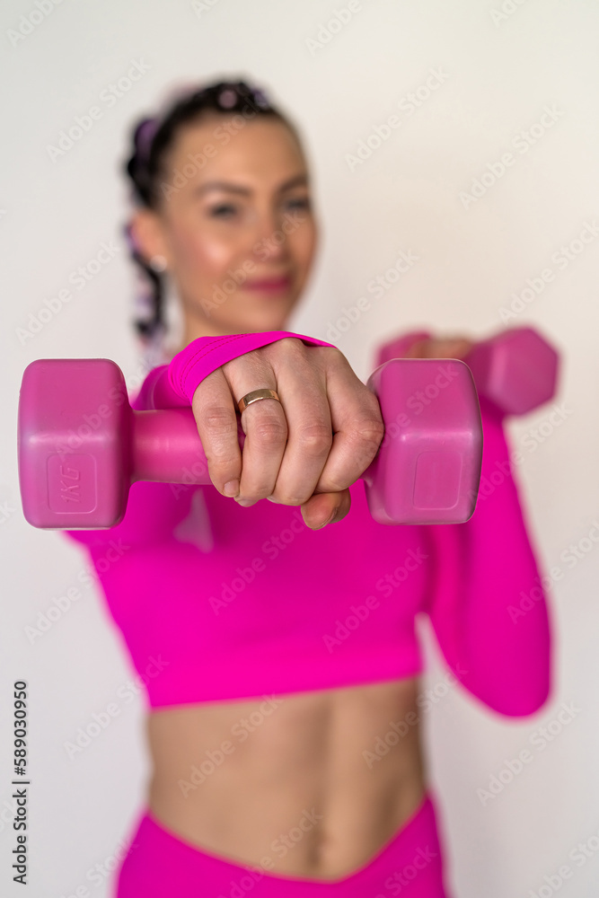 healthy young fitness woman doing exercises with dumbbells isolated on white background. healthy young fitness woman doing exercises with dumbbells isolated on white background.