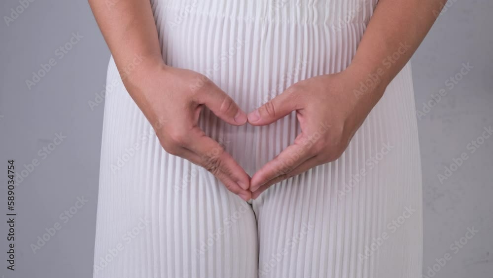 Woman holding heart shape hands on her crotch isolated on white background. Gynecological and Health hygiene concept. Woman holding heart shape hands on her crotch isolated on white background. Gynecological and Health hygiene concept.