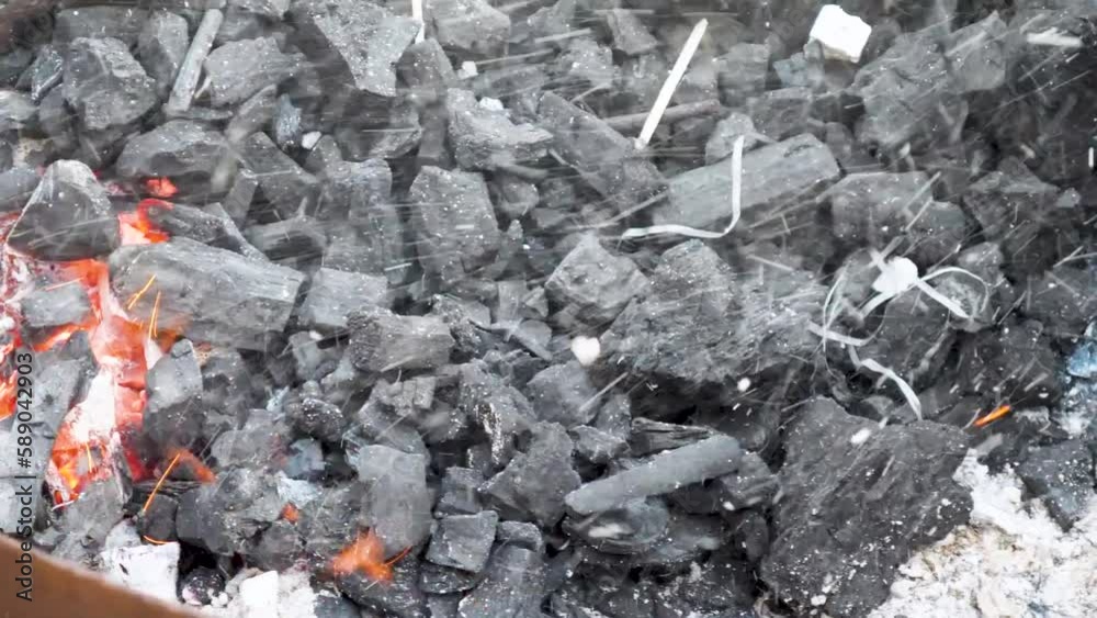 Reviving vivid fire embers over Charcoals in bright fire. Fire embers streaking and flickering above a fire. Reviving vivid fire embers over Charcoals in bright fire. Fire embers streaking and flickering above a fire.