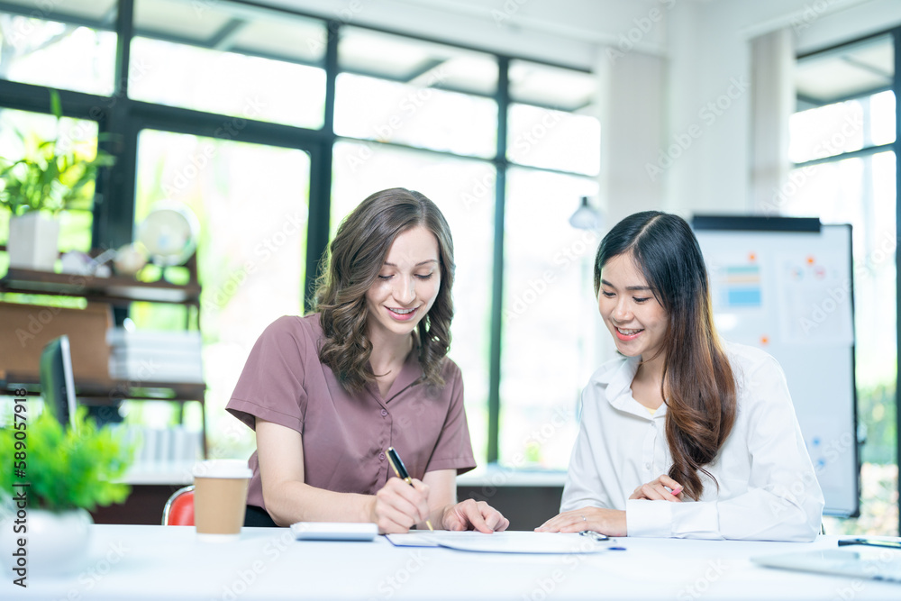 Smiling businesswoman working together on contract document, happy colleague meeting for planning new project in office