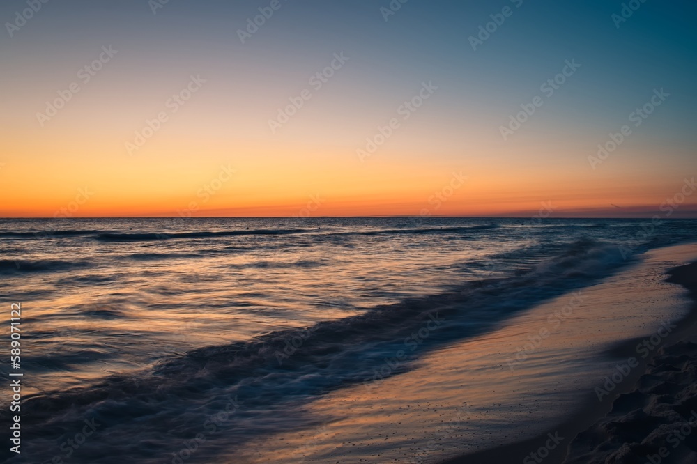 Beautiful colorful landscape on the beach by the sea. Sunrise over the Baltic Sea in Jastarnia, Poland.