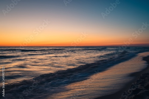 Fototapeta Naklejka Na Ścianę i Meble -  Beautiful colorful landscape on the beach by the sea. Sunrise over the Baltic Sea in Jastarnia, Poland.