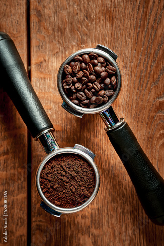 Ground coffee and beans in a holder from a coffee machine on a wooden background. Coffee concept