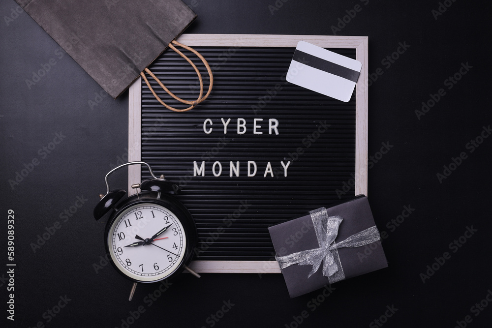 Creative flat lay promotion composition Cyber Monday sale text on board with shopping stuff. Cyber Monday sale mockup promotion advertising. 
