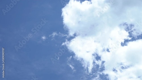 View of clouds moving in a blue sky on a sunny afternoon from the POV of the ground, concept mindful, mindfulness photo
