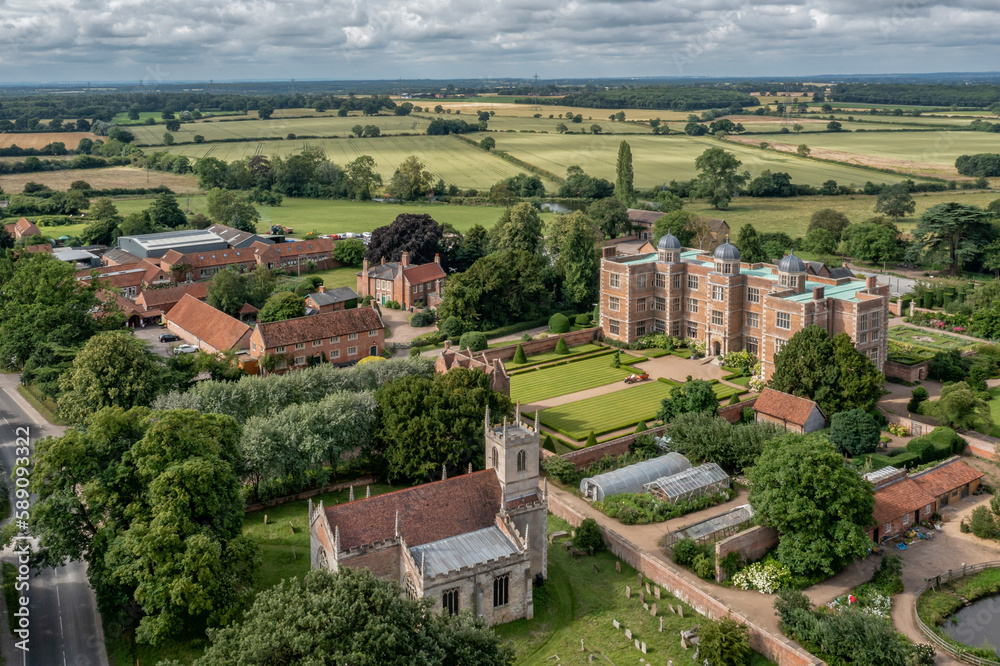 Doddington Hall in Lincolnshire northern England, aerial view of Stately Home on a sunny day showing countryside, church and Hall