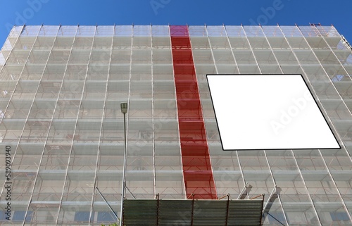 Blank information board on the facade under complete refurbishment to improve the energy efficiency building. Copy space.	