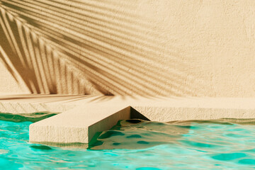 Tropical summer background with concrete wall, pool water and palm leaf shadow. Luxury hotel resort exterior for product placement. Outdoor vacation holiday house scene, neutral architecture aesthetic