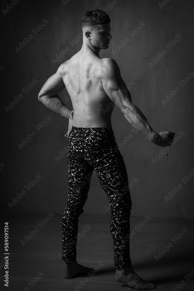 Fototapeta premium A guy in a great sports uniform in the studio on a gray background.