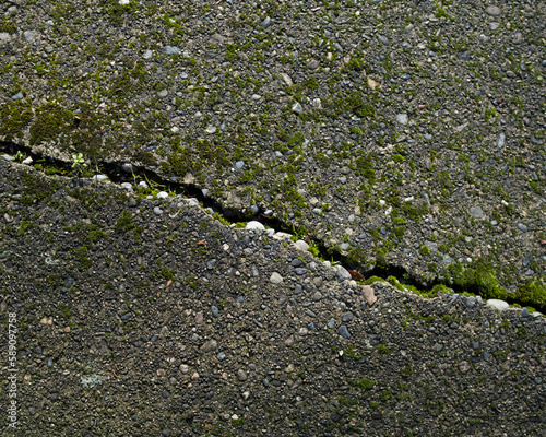 A crack in the paving, highlighted by white paint.