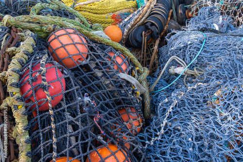 A pile of commercial fishing nets with ropes and floats. photo