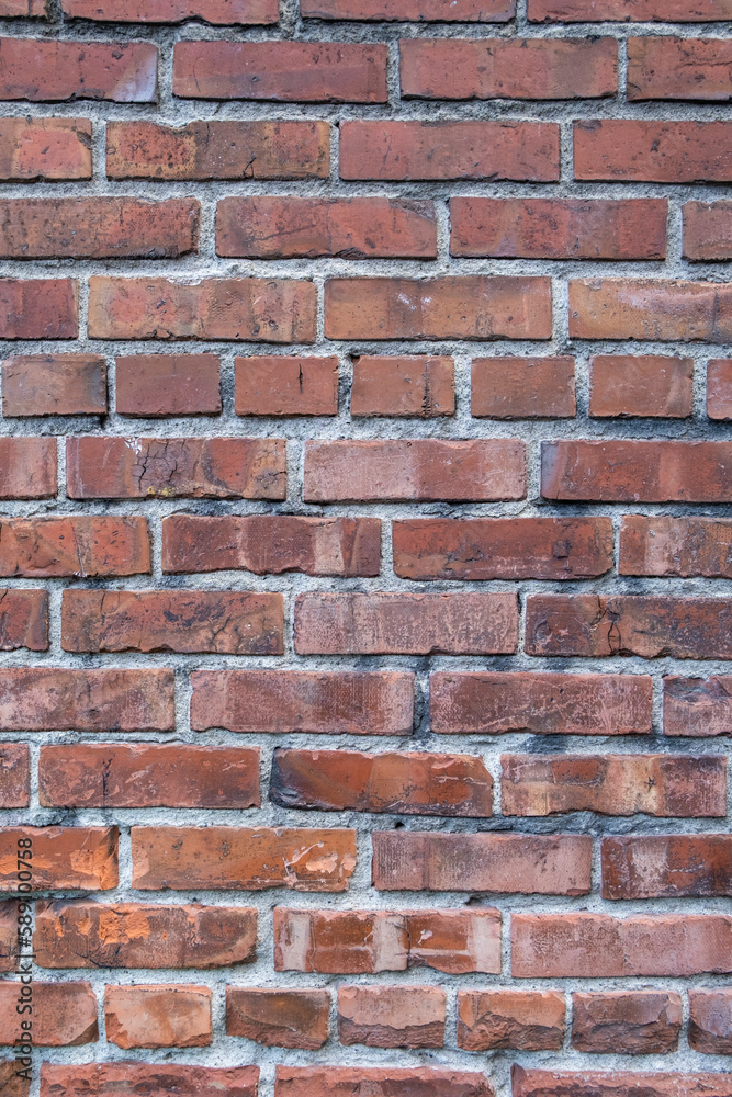 A brick wall, red clay bricks laid in a regular pattern to make a wall. A brick wall, red clay bricks laid in a regular pattern to make a wall.