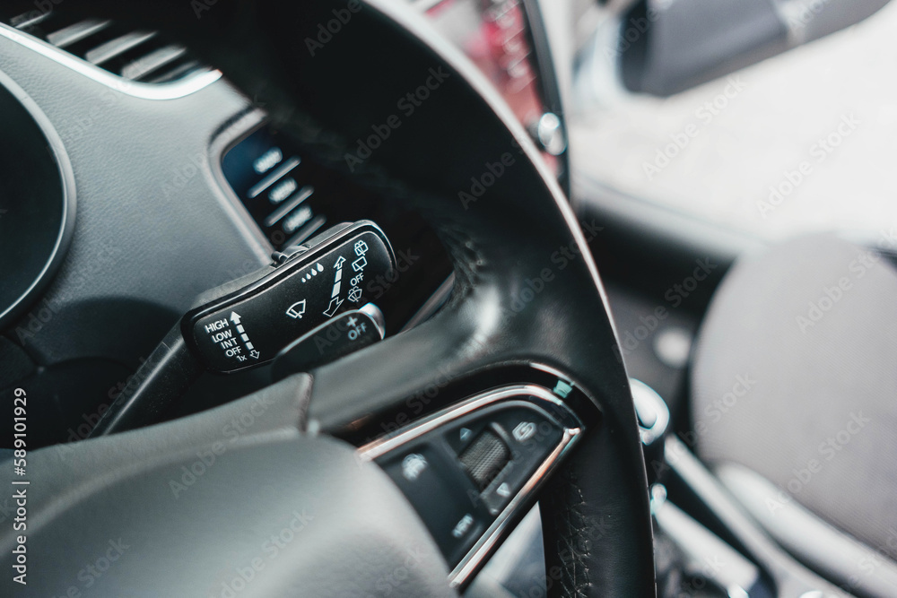 Modern black car interior, leather steering wheel, climate control, navigation, air ducts, deflectors on the car panel. Details interior. Modern black car interior, leather steering wheel, climate control, navigation, air ducts, deflectors on the car panel. Details interior.