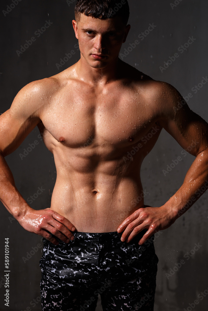 Fototapeta premium A guy in a great sports uniform in the studio on a gray background.
