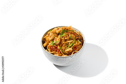 Asian fried noodles with chicken and vegetables isolated on white background Chinese fried noodles with chicken meat and shiitake mushrooms in ceramic bowl. Stir-fry udon with vegetables and meat