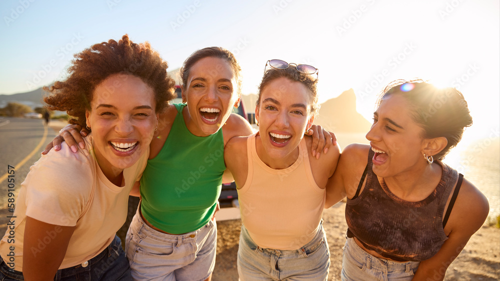 Portrait Of Smiling Female Friends Standing By Car Having Fun On Road Trip Through Countryside Portrait Of Smiling Female Friends Standing By Car Having Fun On Road Trip Through Countryside