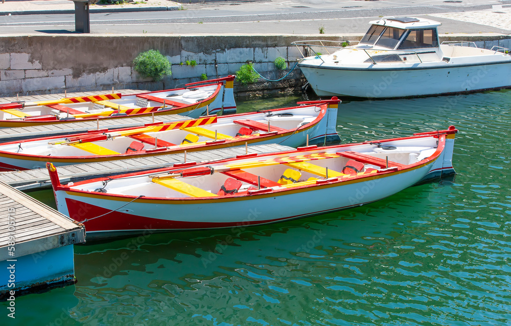 Obraz premium White moored boat on a river are ocean with rope.