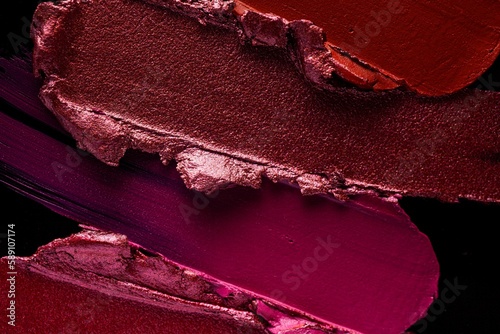 Red pink purple lipstick black background texture smudged